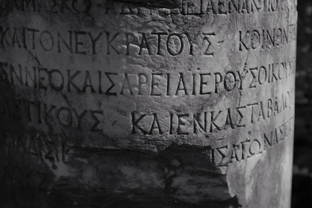 a close up of a stone pillar with writing on it