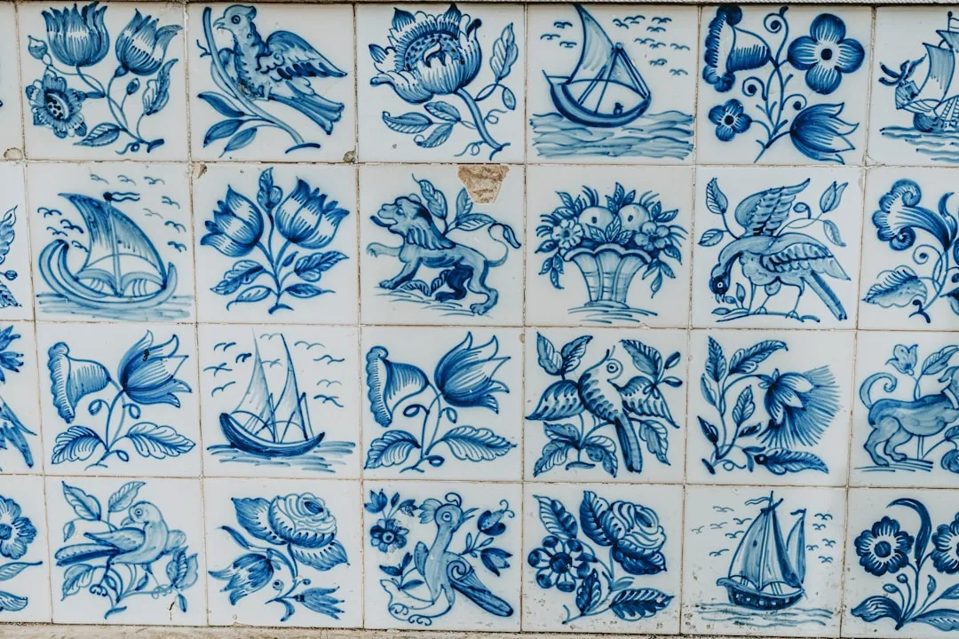 a blue and white tiled wall with a bunch of flowers