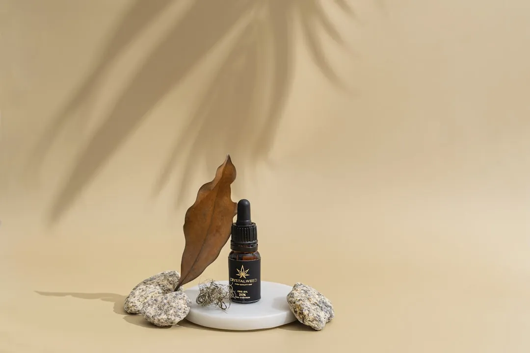 a bottle of essential oil sitting on top of a white plate