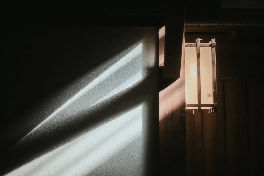 Sunlight streams through a window onto a wall.