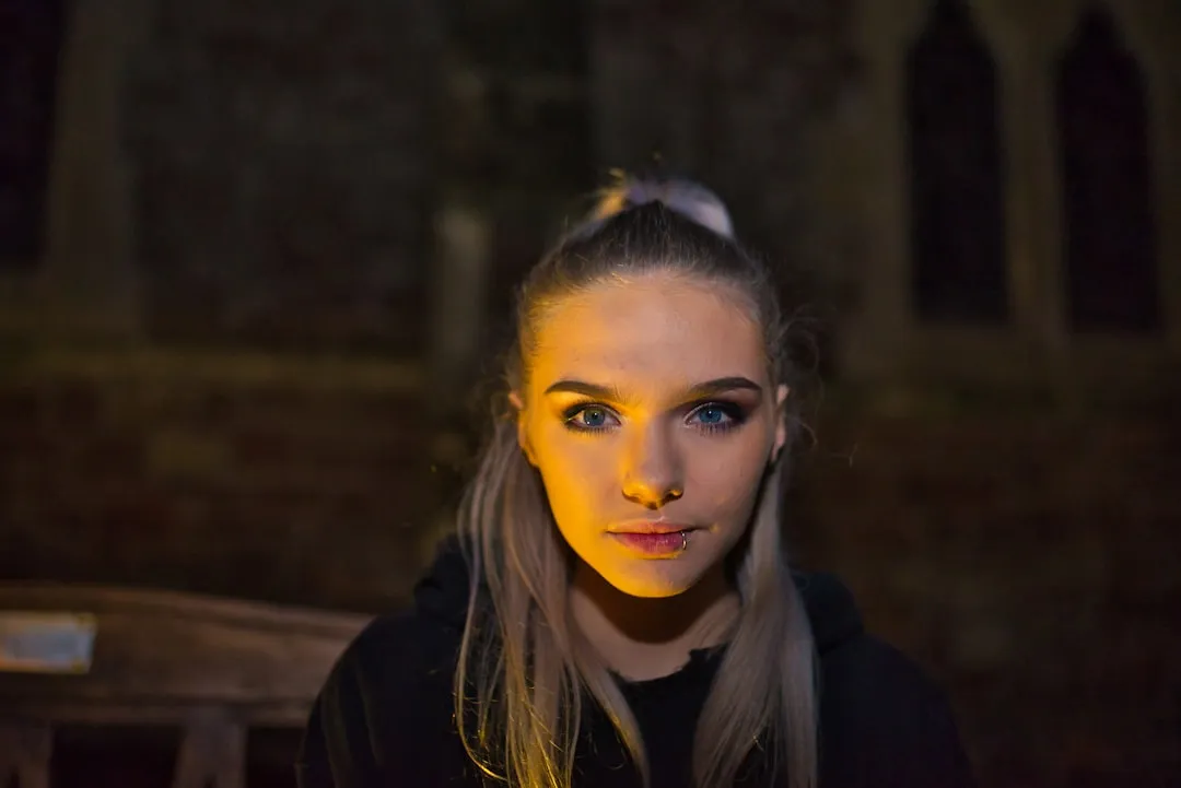 woman wearing black hooded jacket looking straight