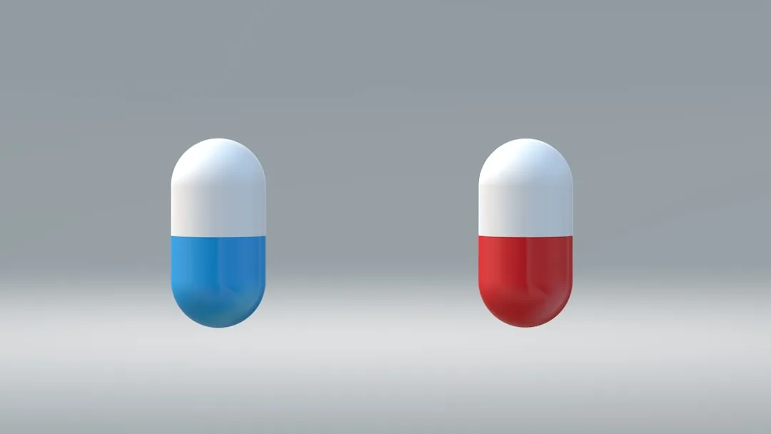 a red, white and blue pill pill sitting next to each other