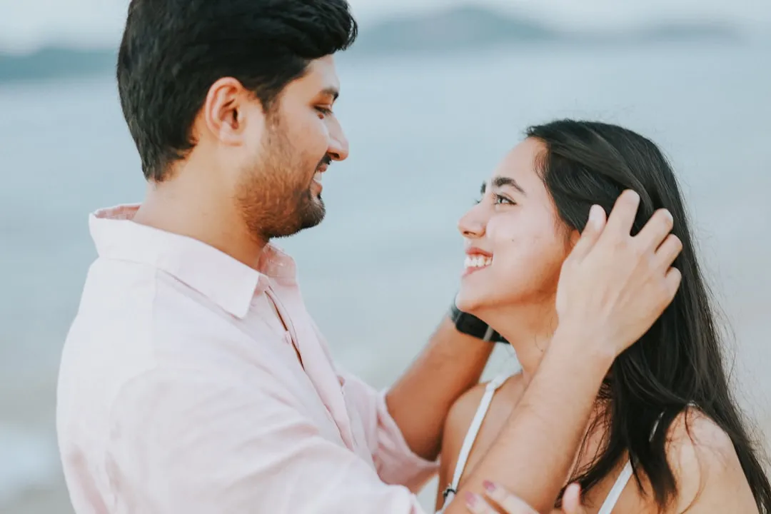 Couple smiling at each other on a beach