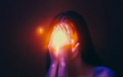 A woman covering her face with her hands