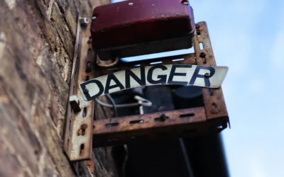 Rusty metal sign with the word danger.