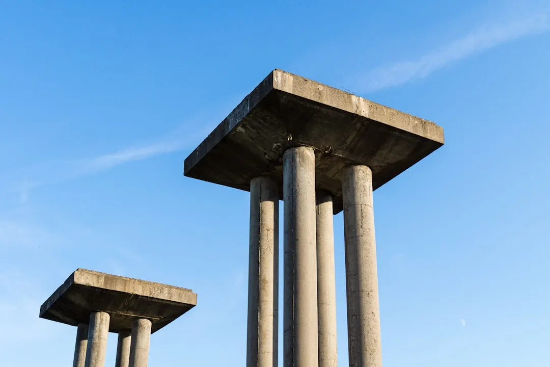 a couple of tall cement pillars sitting next to each other