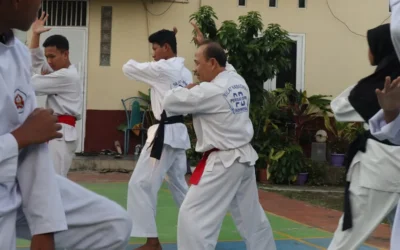 A group of men practicing karate in front of a building
