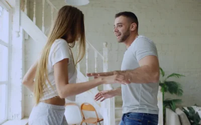 Couple dancing together in a bright room.