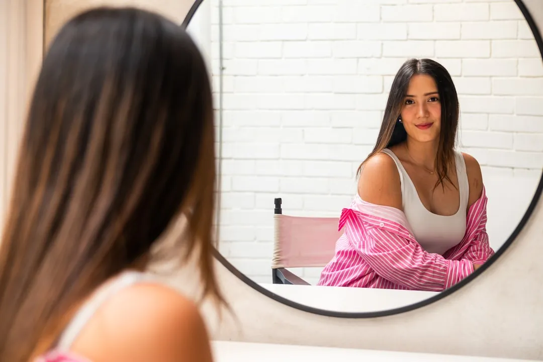 A woman looking at herself in the mirror