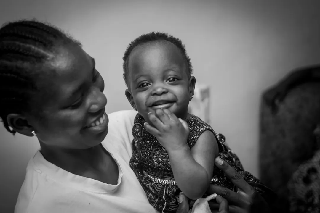 Mother holding a smiling baby in her arms