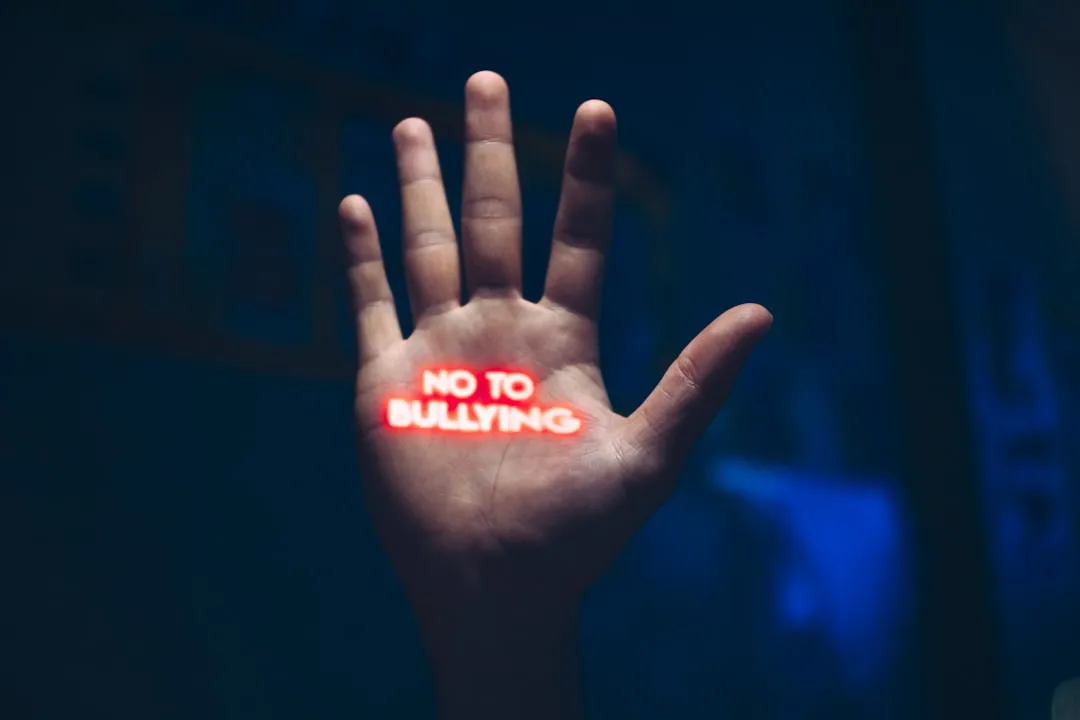 a hand with the word no to bullying written on it