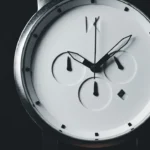 a close up of a wrist watch with a black background