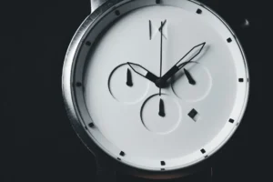 a close up of a wrist watch with a black background