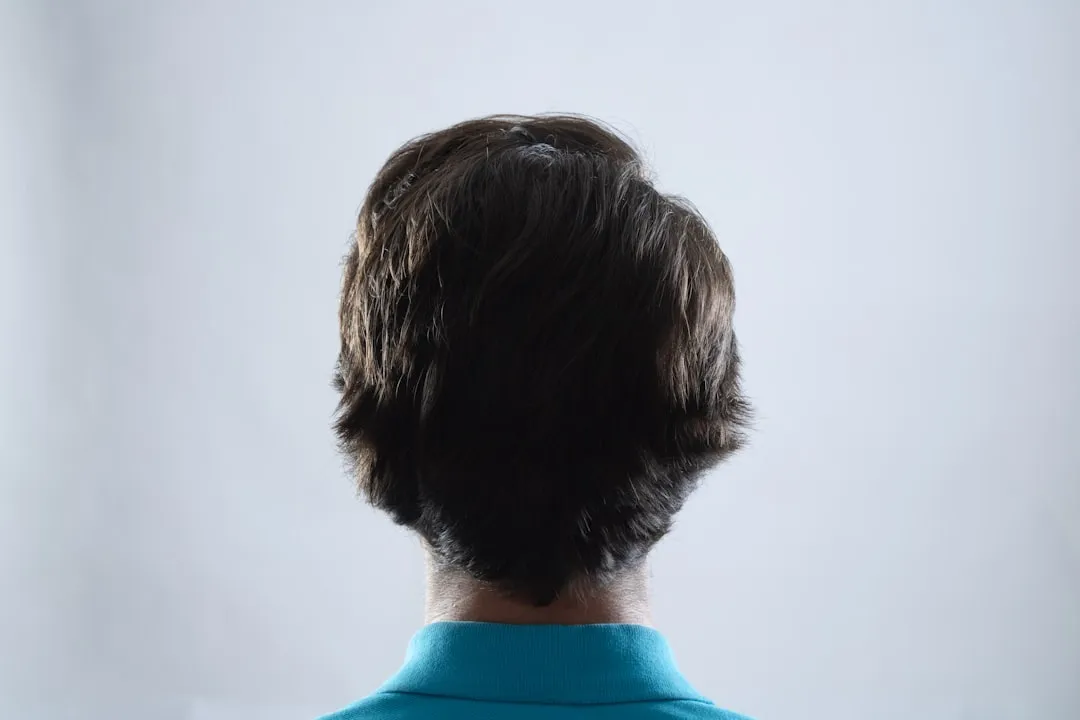 The back of a man's head in a blue shirt
