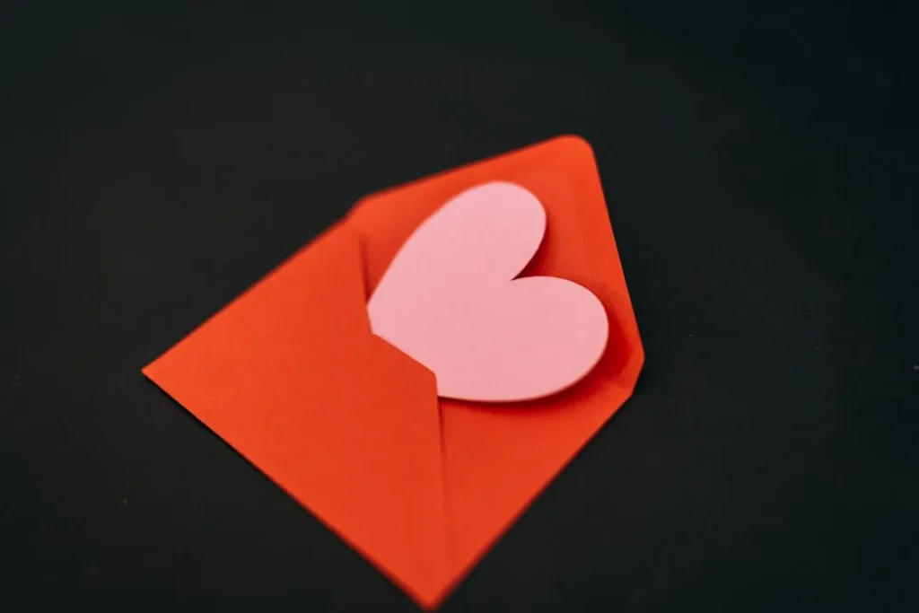 a red envelope with a heart cut out of it