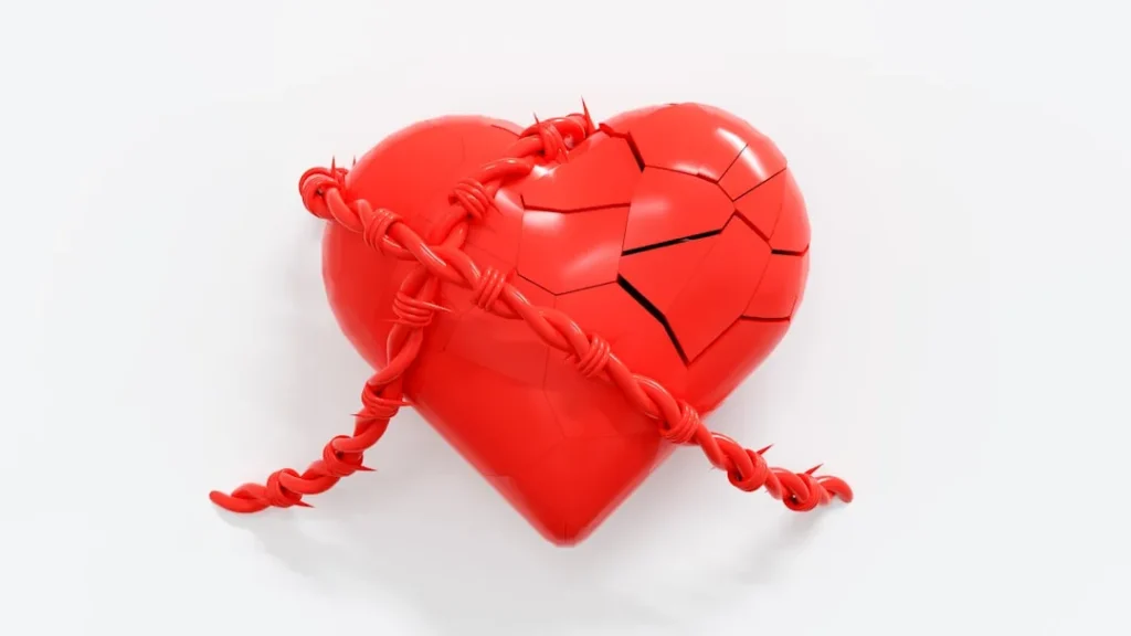 A broken red heart with a rope attached to it