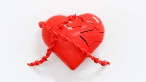 A broken red heart with a rope attached to it