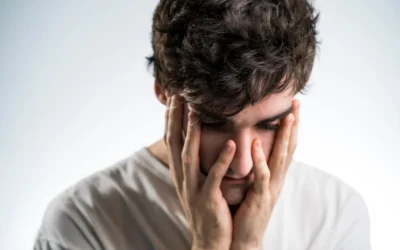 man touching face with both hands