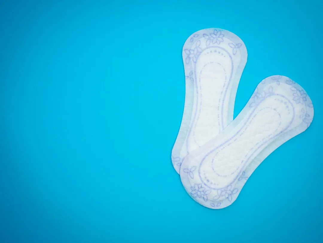 a pair of sanitary pads sitting on top of a blue surface