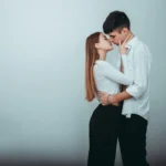 a man and woman kissing