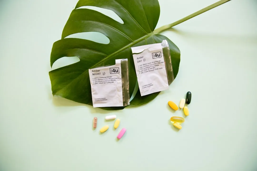 white and yellow medication pill on green leaf