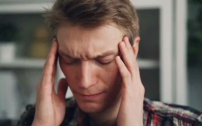 a man holding his hands to his ears