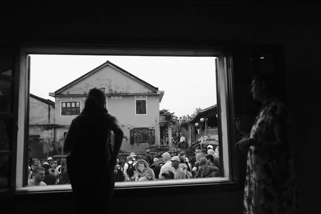 People gathered outside looking through window