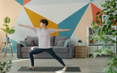 Woman practicing warrior two pose in a living room.