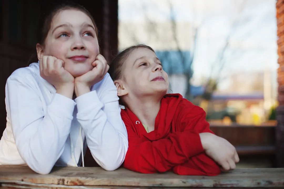 a person and a girl sitting on a bench