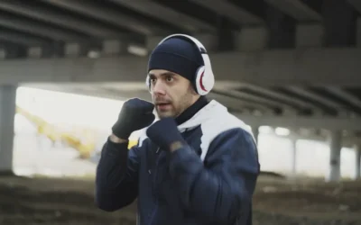 Man in headphones boxing under a bridge