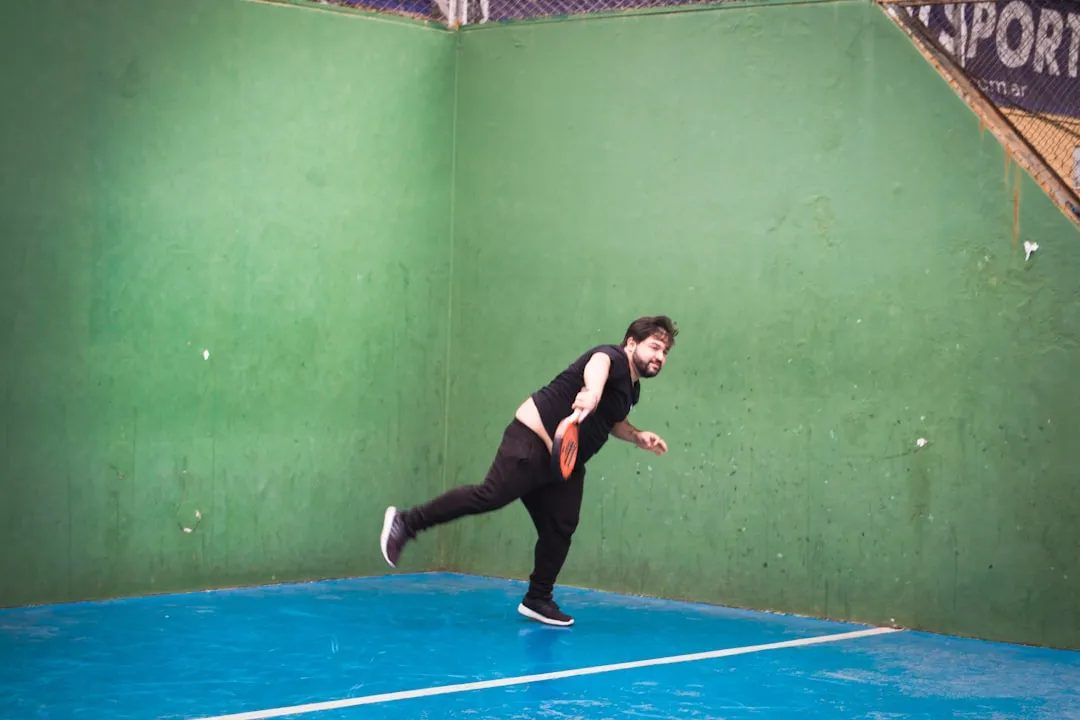 a man is playing tennis on a court