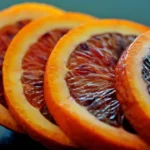 a close up of sliced blood oranges on a table