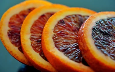 a close up of sliced blood oranges on a table