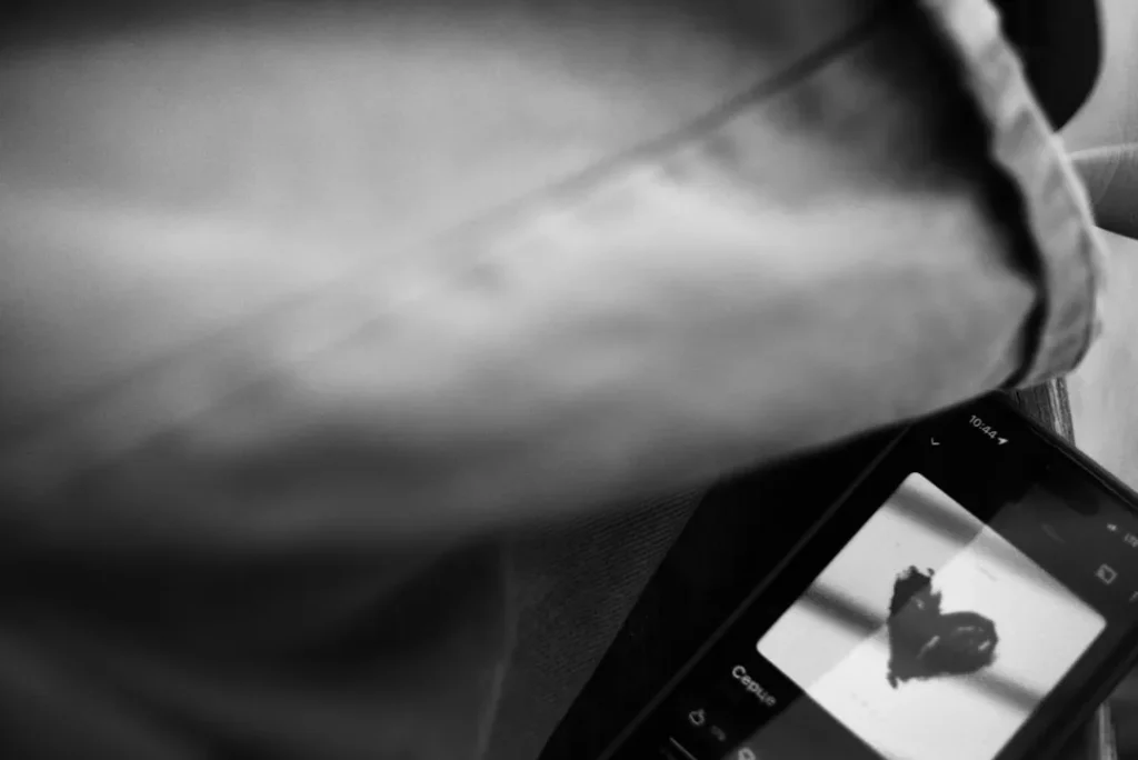 Smartphone screen displays a hand-drawn heart symbol.