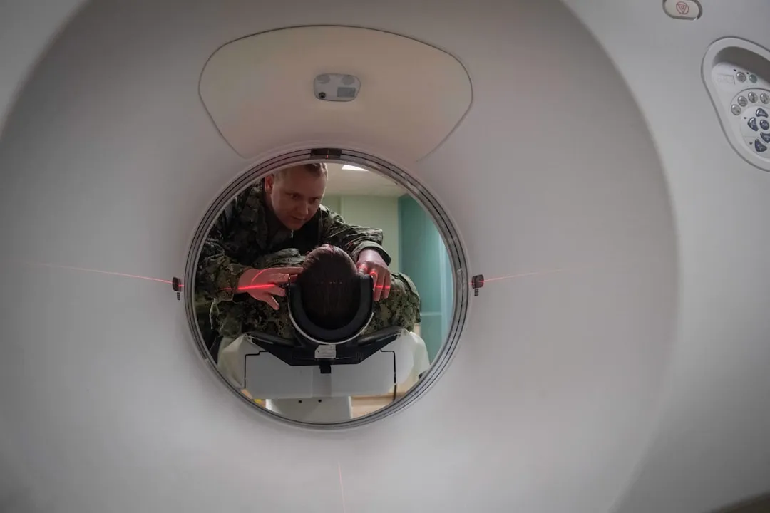 Technician positions patient in ct scanner