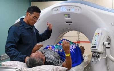 Medical professional assists patient during ct scan procedure.