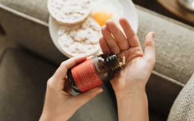 person holding red bottle