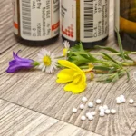 A bottle of medicine sitting on top of a wooden table