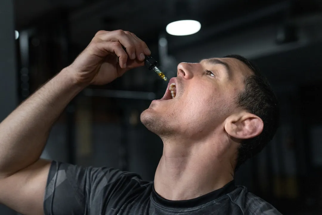 Man taking liquid from dropper into mouth