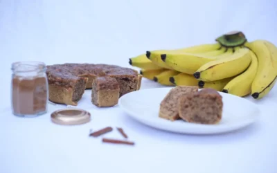 A white plate topped with slices of cake next to bananas