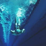 man swimming in swimming pool