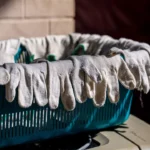 Gloves are hanging over the edge of a basket.