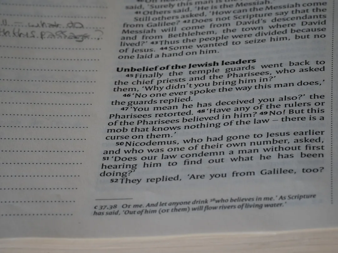 A close up of an open book with writing on it