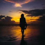silhouette of woman standing on seashore