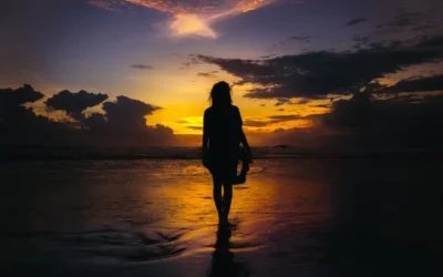 silhouette of woman standing on seashore