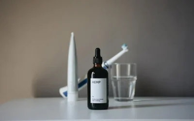 a bottle of liquid sitting on top of a table next to a toothbrush