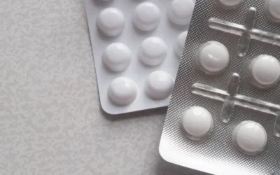a pack of pills next to a contraption on a table