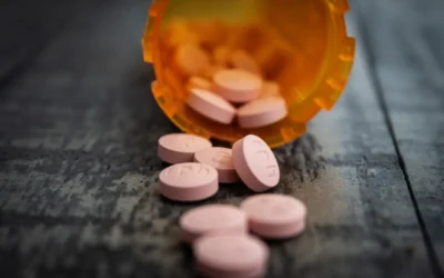 white medication pill on orange plastic container