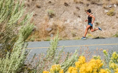 woman in black tank top running on gray asphalt road during daytime