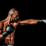 a man with a bald head wearing boxing gloves
